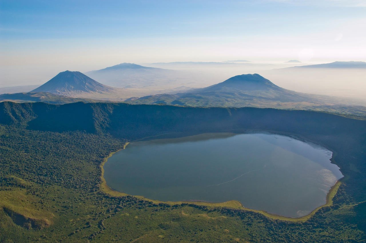 Tanzania, Ngorongoro Crater hosts an astonishing concentration of wildlife — including rhinos, lions, elephants, and flamingos — all set against lush, dramatic landscapes.